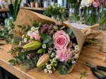 Example work photo: a finished bouquet on a florist’s bench