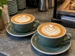 Example work photo: two flat whites on a café counter