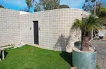 A curved white block wall by Ash Huskisson Masonry