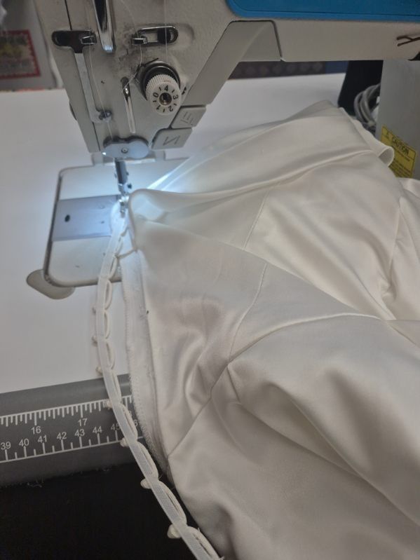 A bridal gown hem at the sewing machine
