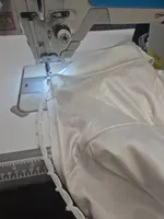 A bridal gown hem at the sewing machine