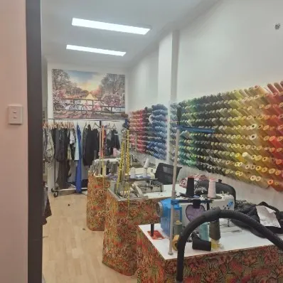 The thread wall and sewing tables in the workroom